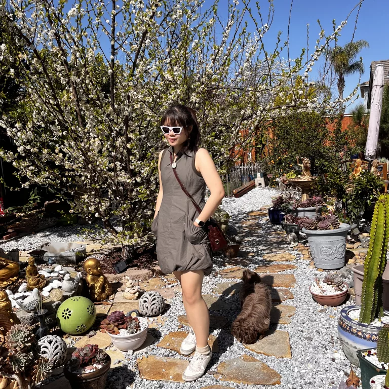 Tennis dress with white sneakers and white cat eye sunglasses