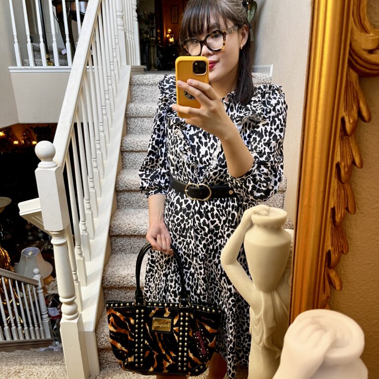 Woman in animal print dress taking selfie