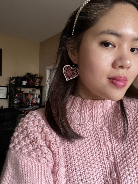 Woman selfie in pink sweater